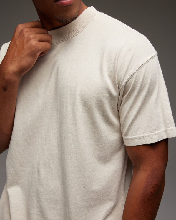 Male model wearing the Mock Neck Tee, shop all Men's T-shirts.
