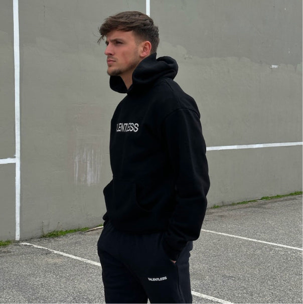 Luca wearing the men's hoodie