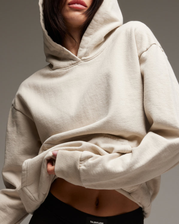 Female model wearing Women's Heavyweight Hoodie. Shop All Women's Hoodies & Sweatshirts.